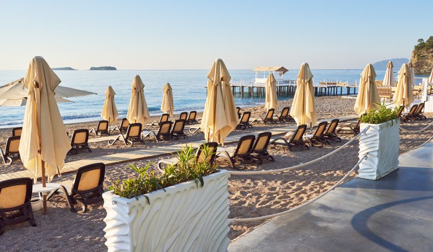 scenic view private sandy beach with sun beds parasokamy sea mountains resort